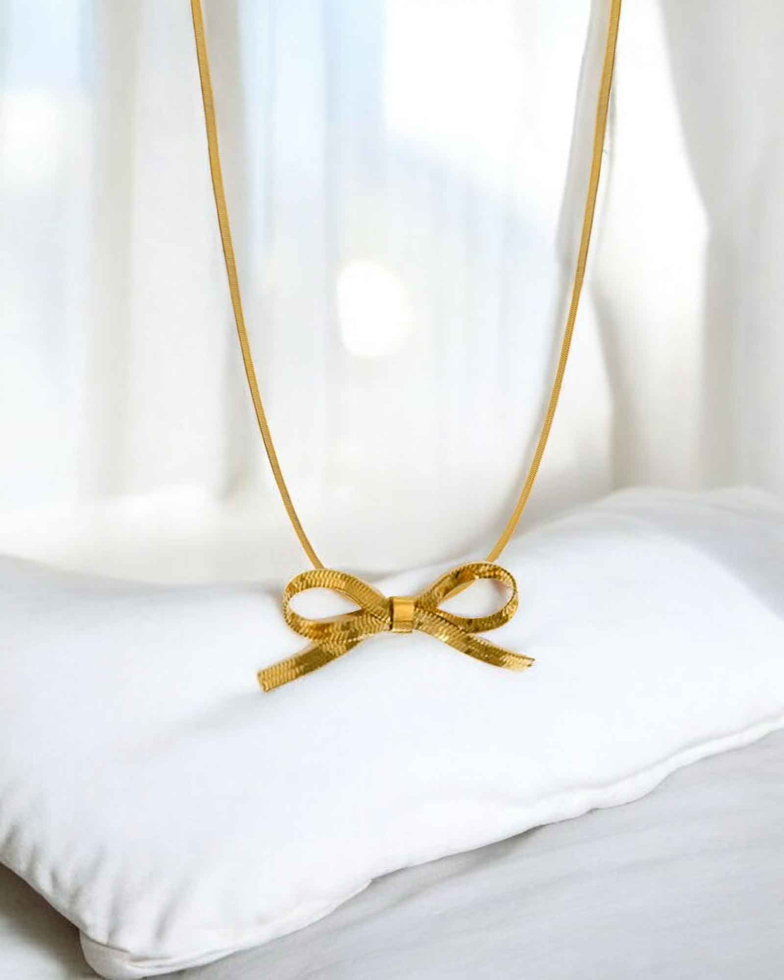 Bow tie pendant necklace